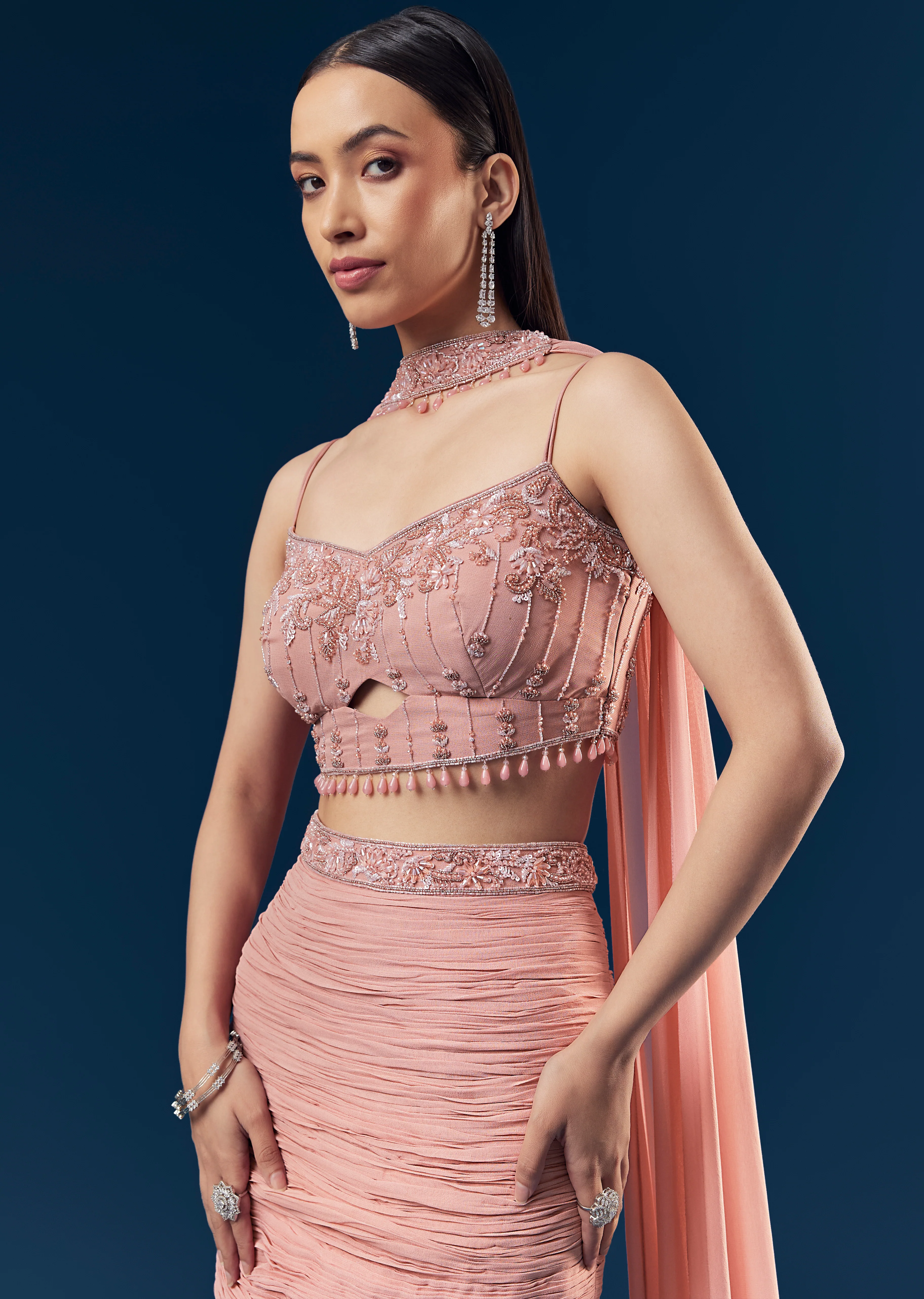 Celebration Couple Set – Blush Pink Georgette Fish-Cut Lehenga with Embroidered Sleeveless Blouse & Choker Dupatta for Her And Pink Jodhpuri-Style Tuxedo Set with Metal Broach for Him - Image 2