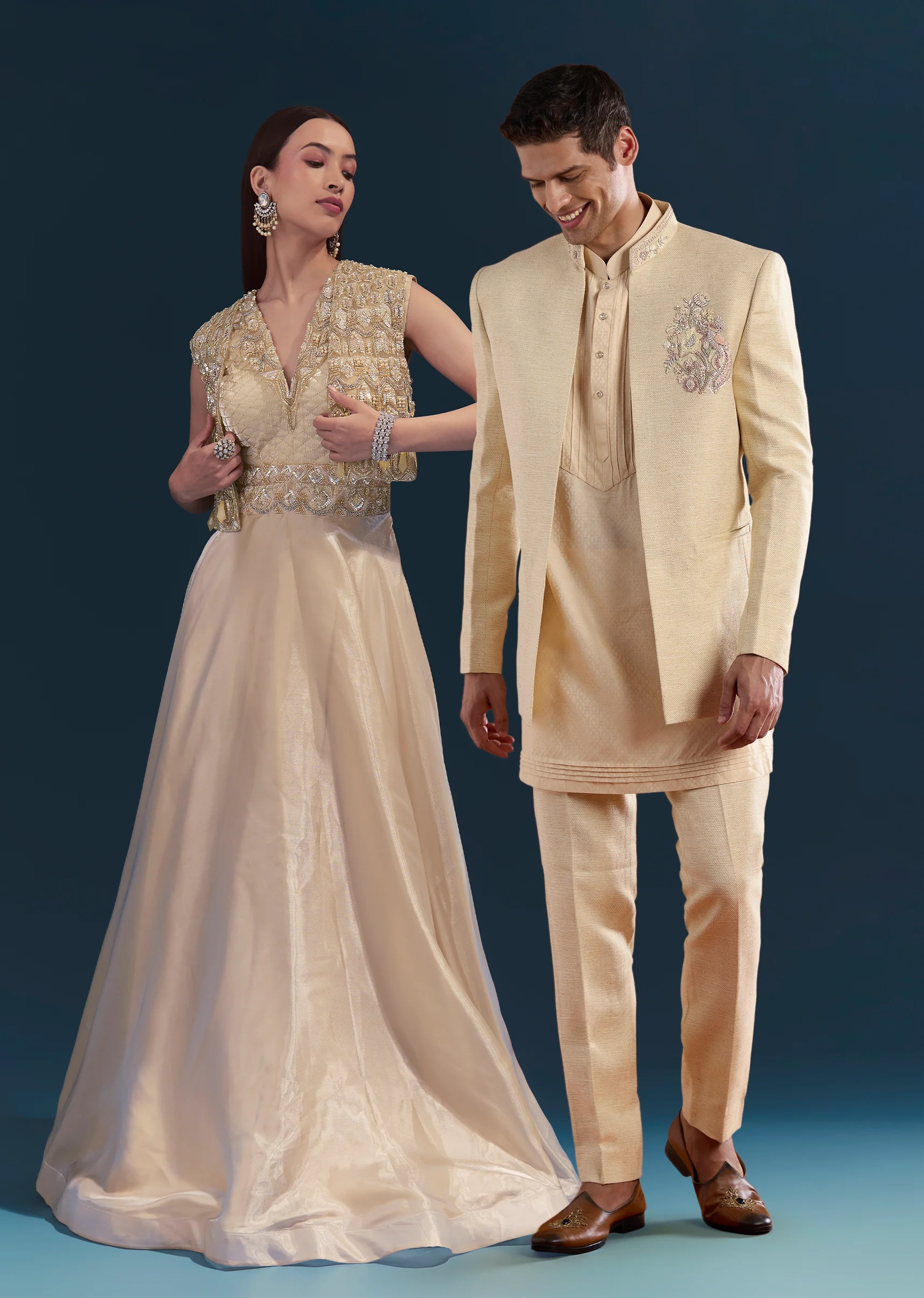 Gold Celebration Duo – Jumpsuit With Jacket For Her And Embellished Jodhpuri Kurta Set For Him
