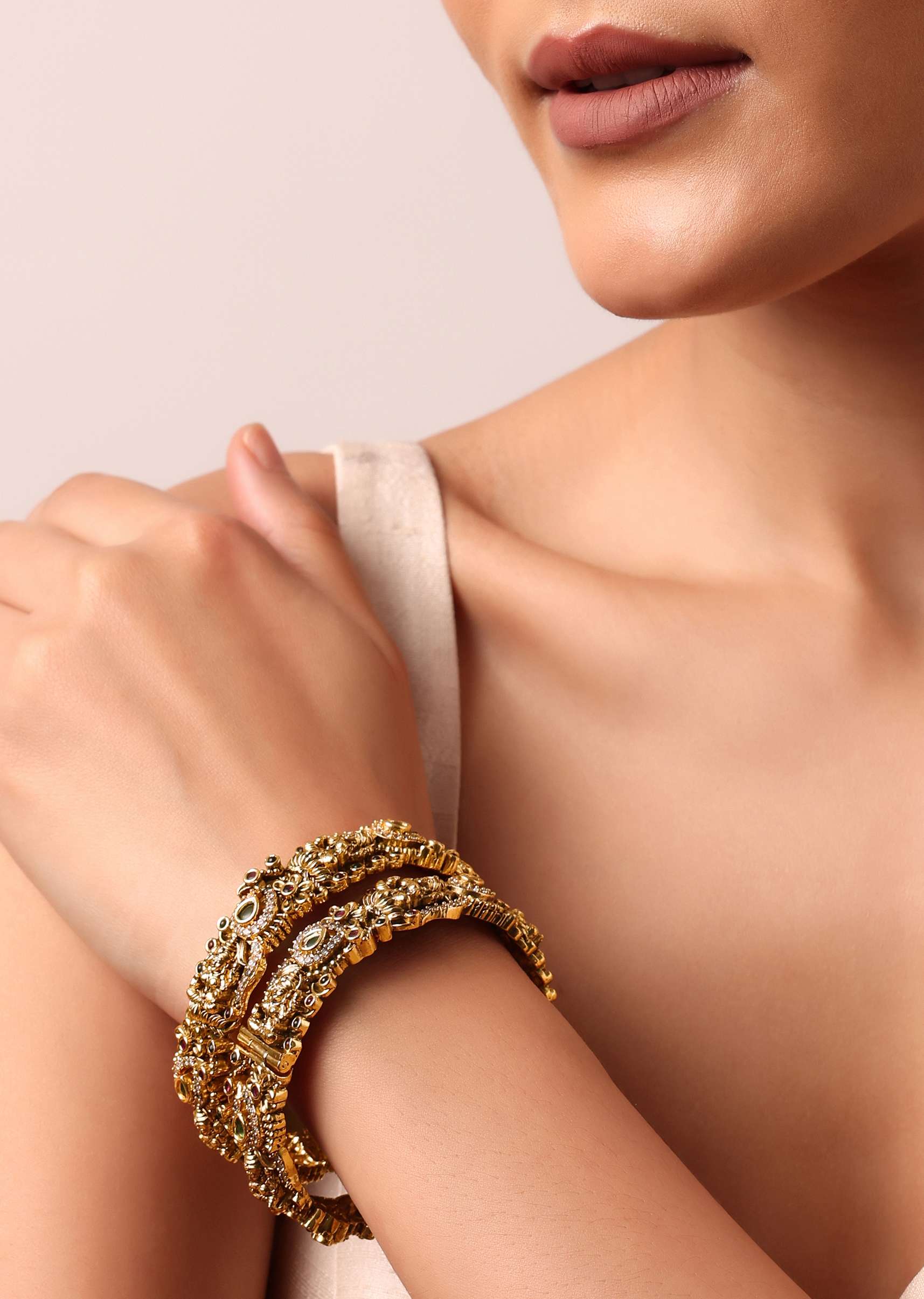 Gold Finish Multi Carved Bangle With Studded Kundan And Motifs Set of 2