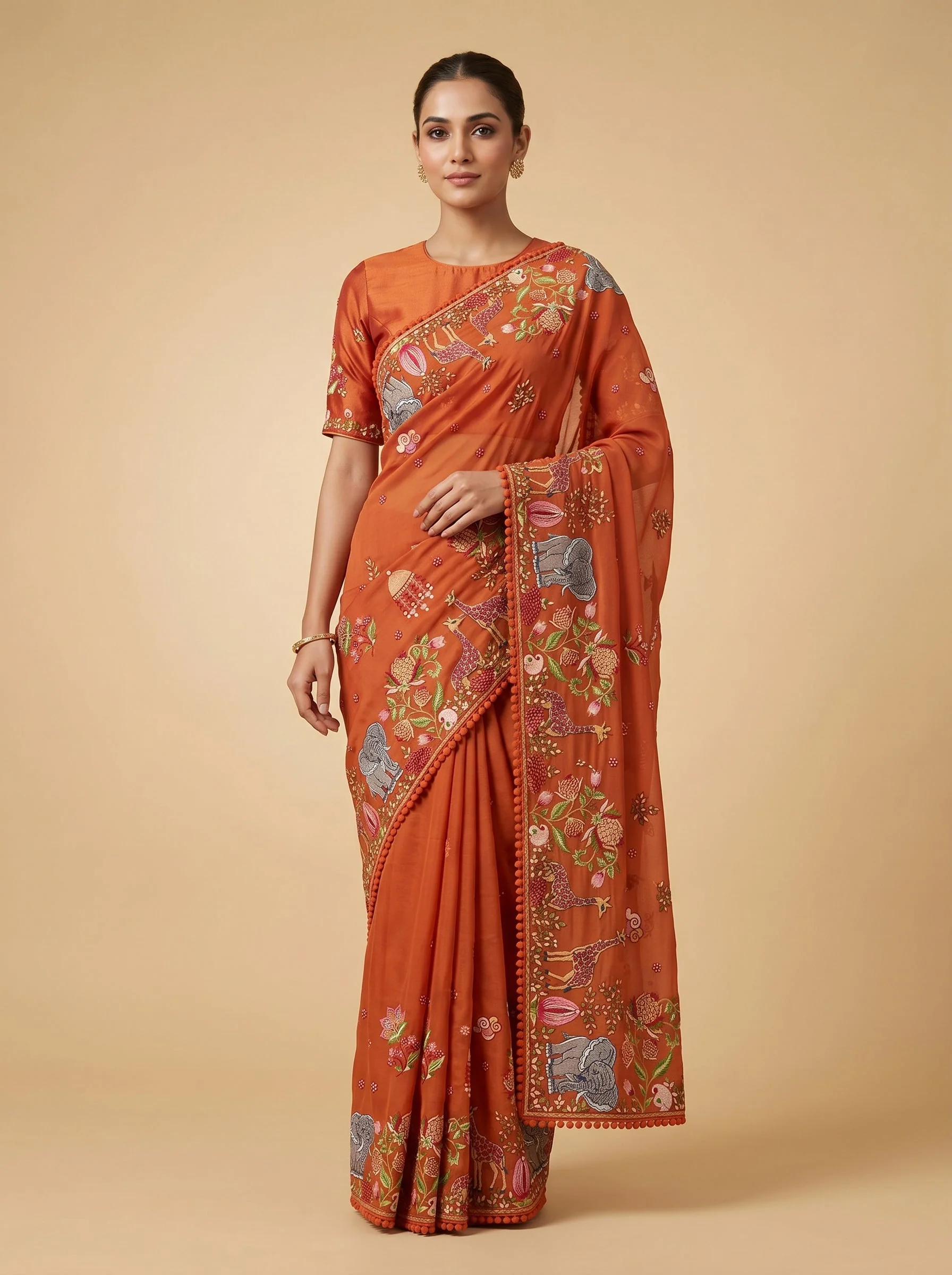 Orange embroidered saree with traditional design