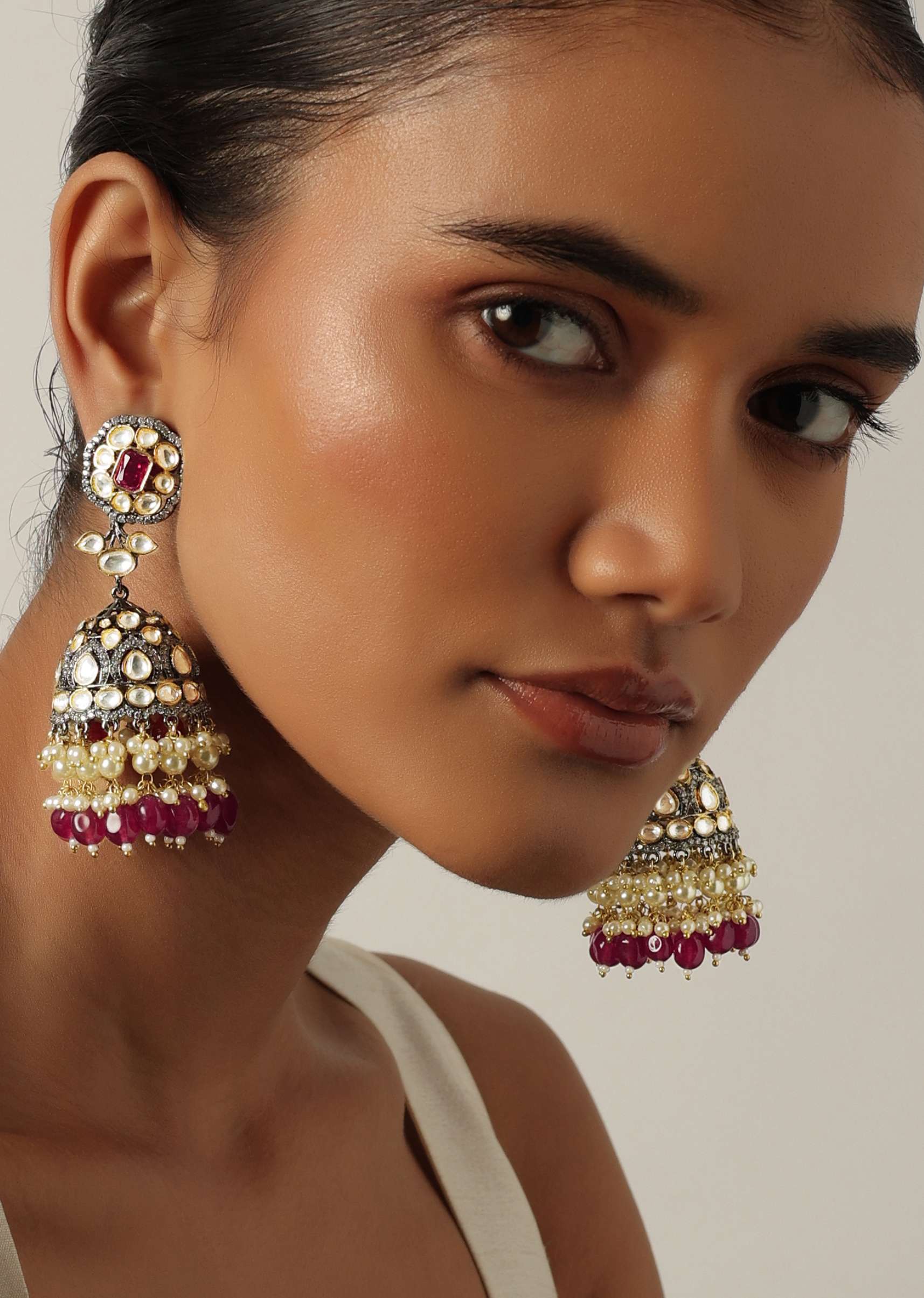 Two Tone Kundan Jhumkas With Embedded Tiered Red Beads - Image 2