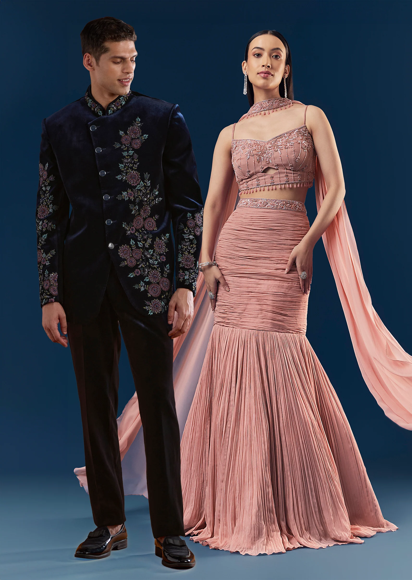Velvet And Pastel Glamour Couple Set – Blush Pink Fish Cut Lehenga for Her And Blue Velvet Jodhpuri Set for Him